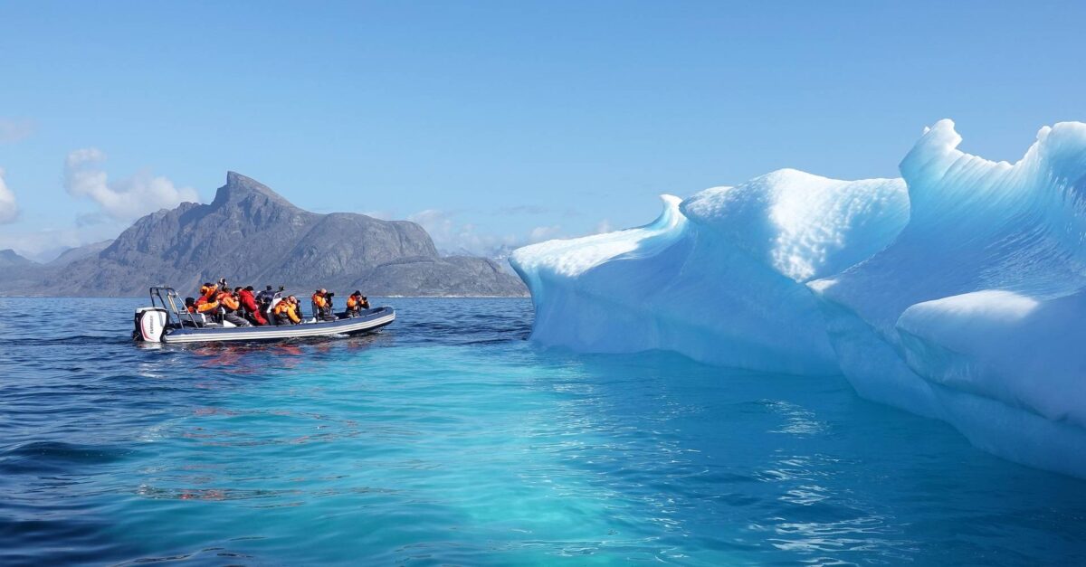Photo of a power boat and an iceberg
