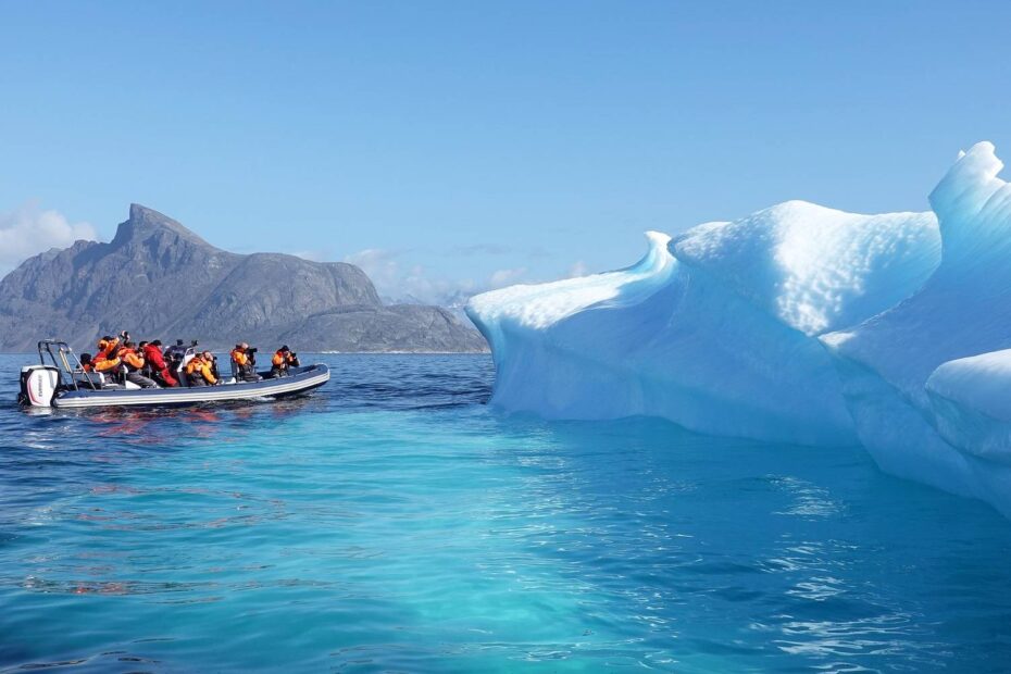 Photo of a power boat and an iceberg