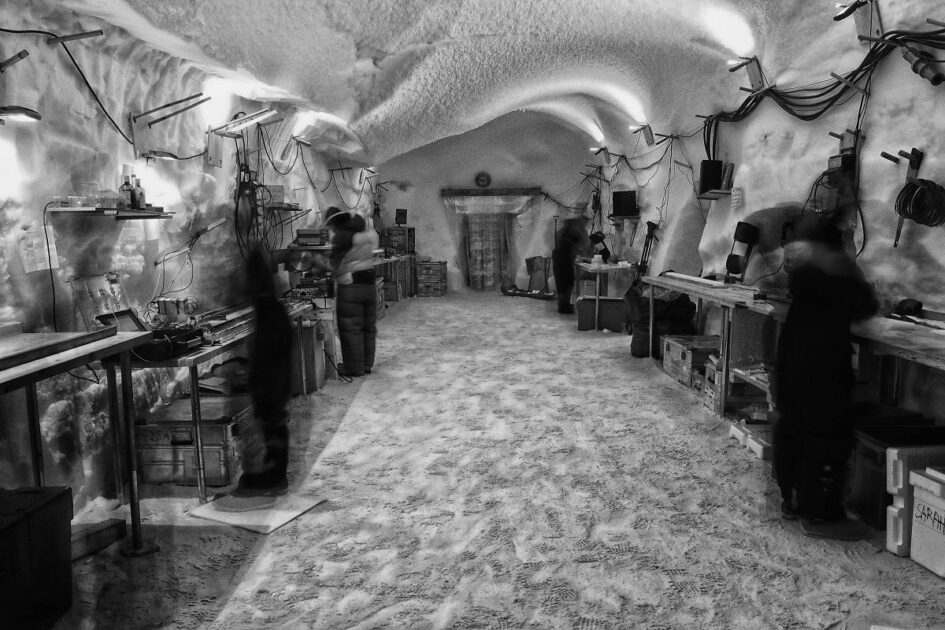 Photo of Climate scientists processing ice core samples in the EastGRIP science trench 10 m under the surface of the Greenland ice cap.