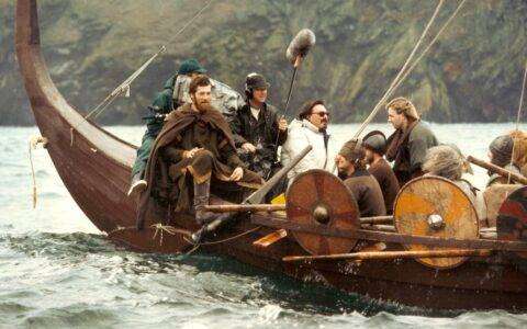 Director Leo Eaton and his camera crew filming aboard a recreated Viking longship off Peel in the Isle of Man in a scene from the VIKINGS episode of Timeline