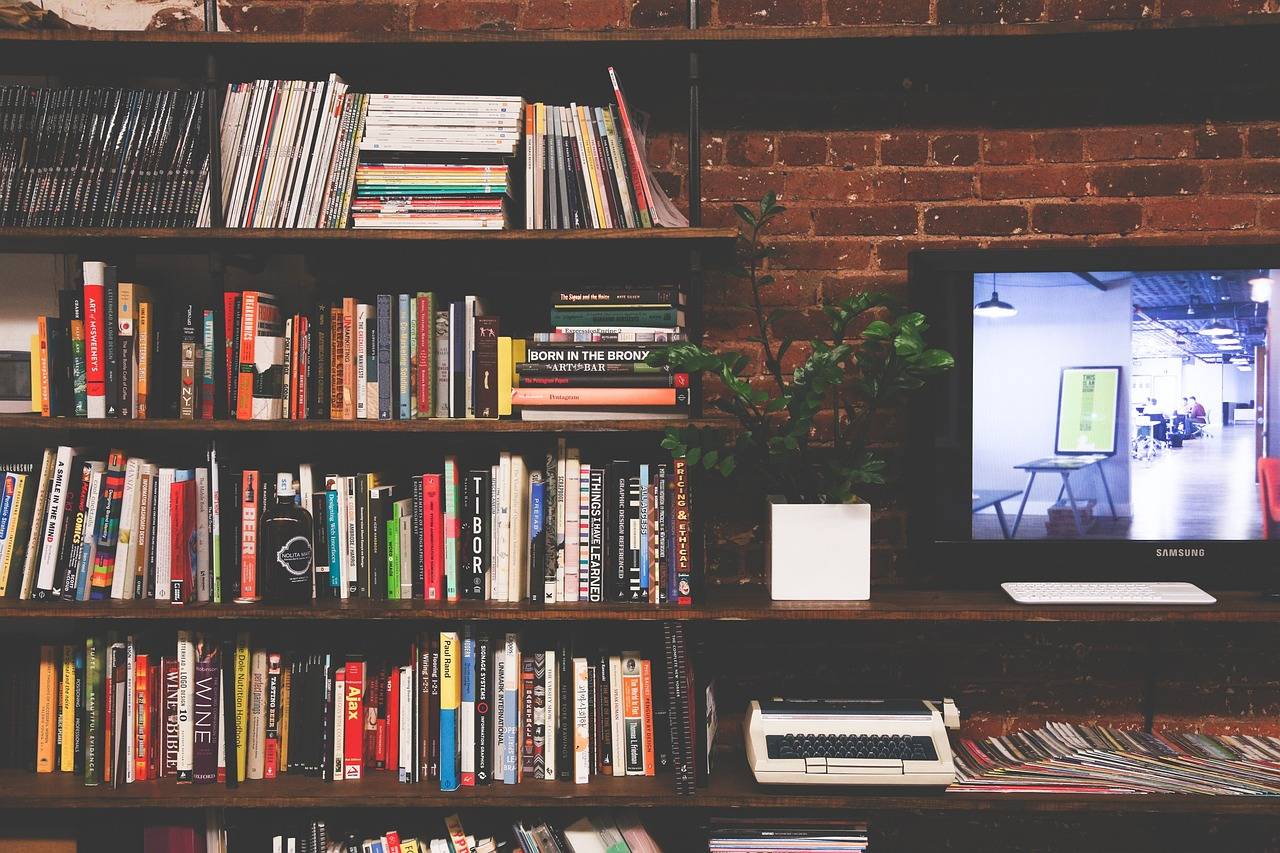 Photo of bookshelves, a typewriter and a TV